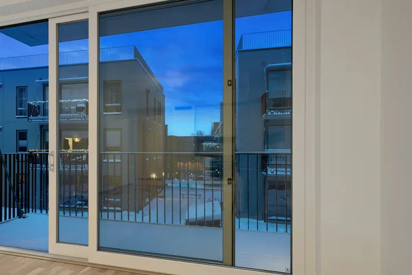 Aluminum-framed sliding glass door installed in a Beirut apartment opening onto a balcony