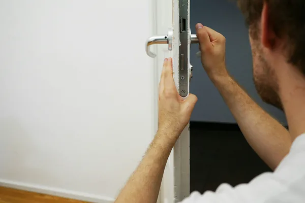 Locksmith in Beirut fitting a mortise lock into an apartment door